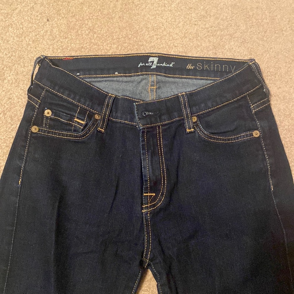 Dark wash, low rise skinny jeans.